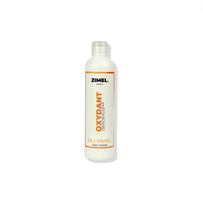 A bottle of Zimel Paris Oxydant Crème 10VOL by JS Organics. which is a hair developer product, primarily in a white and orange packaging.